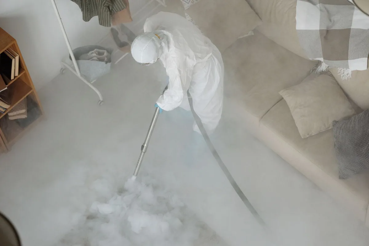 Biohazard cleanup technician in protective equipment, Plumerville, AR